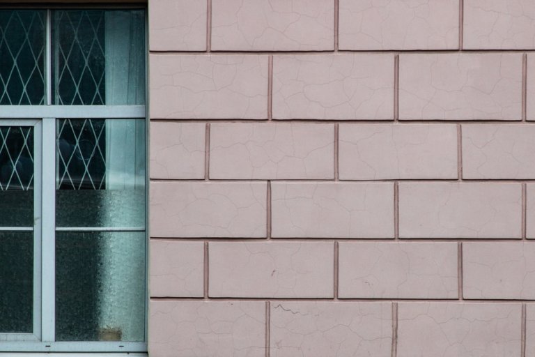 beige brick building with glass window