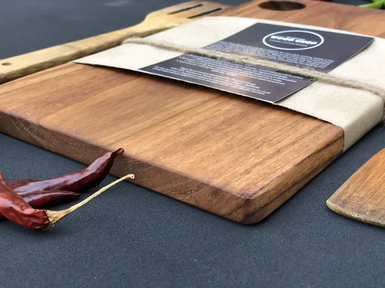 A wooden cutting board with a variety of fresh fruit and vegetables on top. Is Acacia Wood Good for Cutting Boards