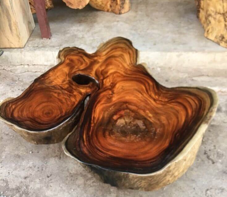 A large wooden bowl on a concrete slab