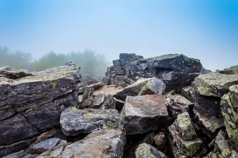 Rocks and fog-covered mountain landscape.